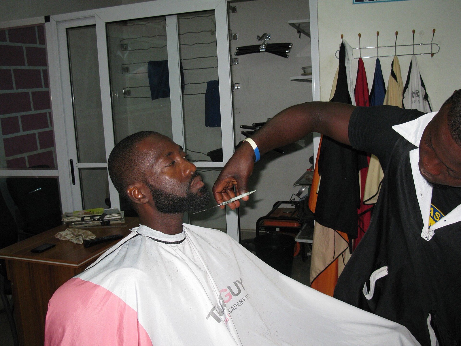 Barber lining up a client's beard
